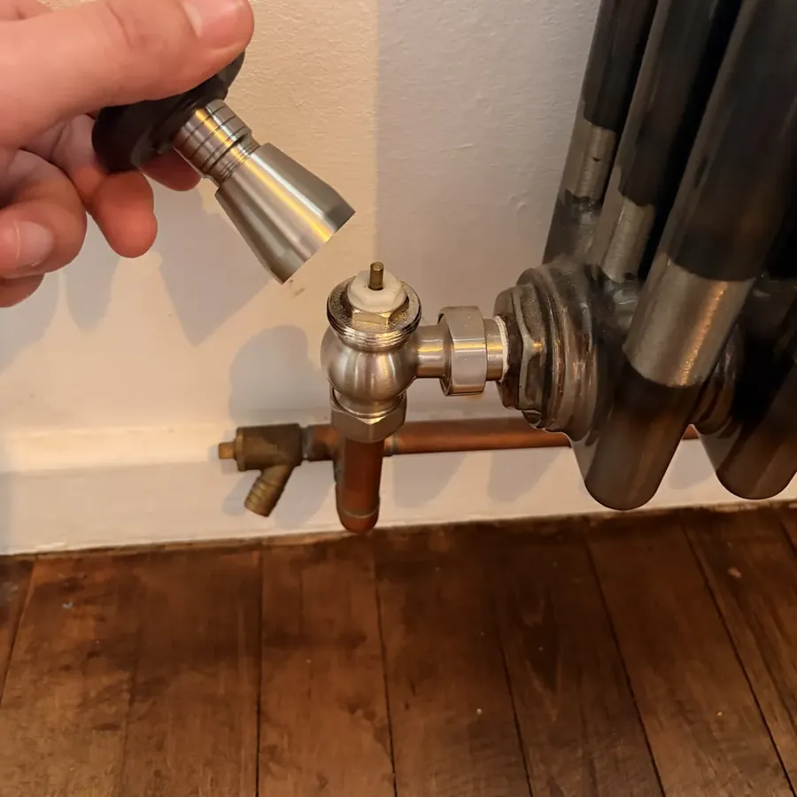 A thermostatic radiator valve being replaced