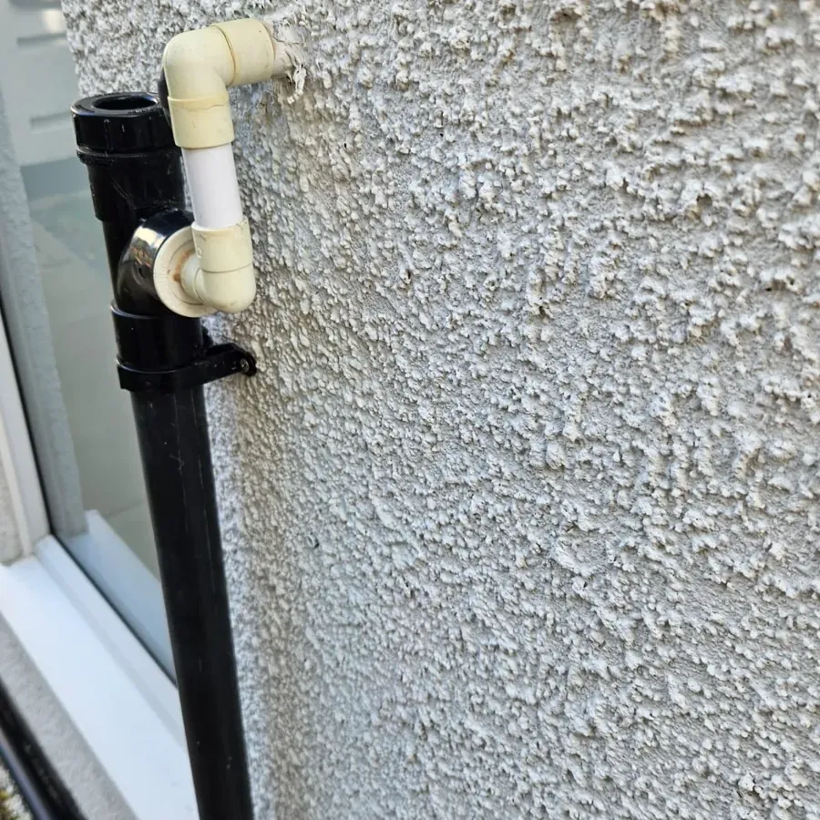 A condensate pipe on an outside wall