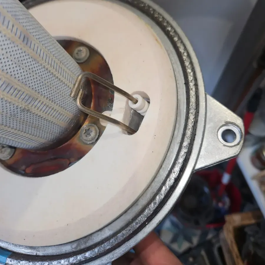 An ignition electrode being replaced on a boiler burner