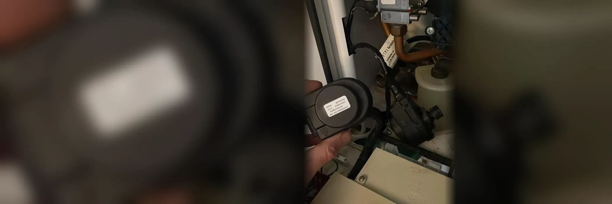A diverter valve being replaced inside a combi boiler