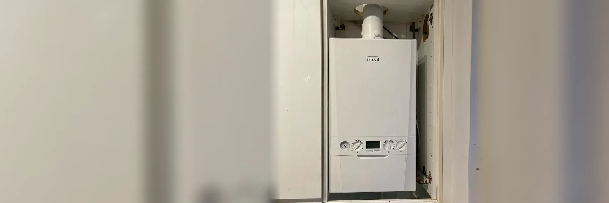 An Ideal Logic combi boiler in a kitchen cupboard