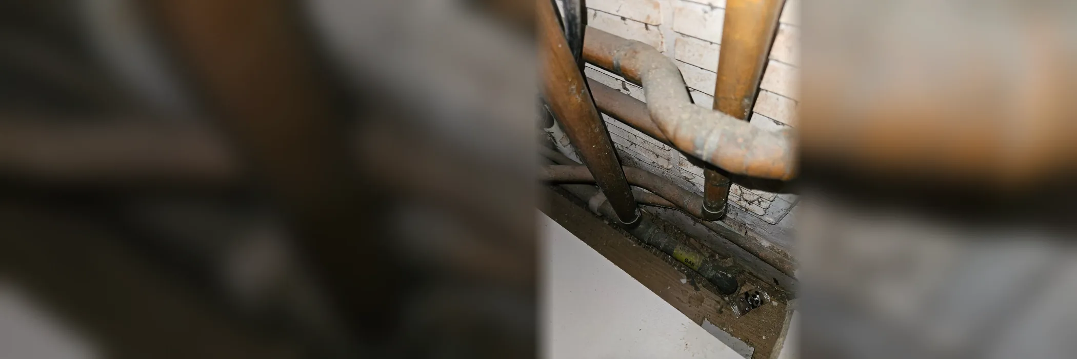 Copper pipes running close together under a floor