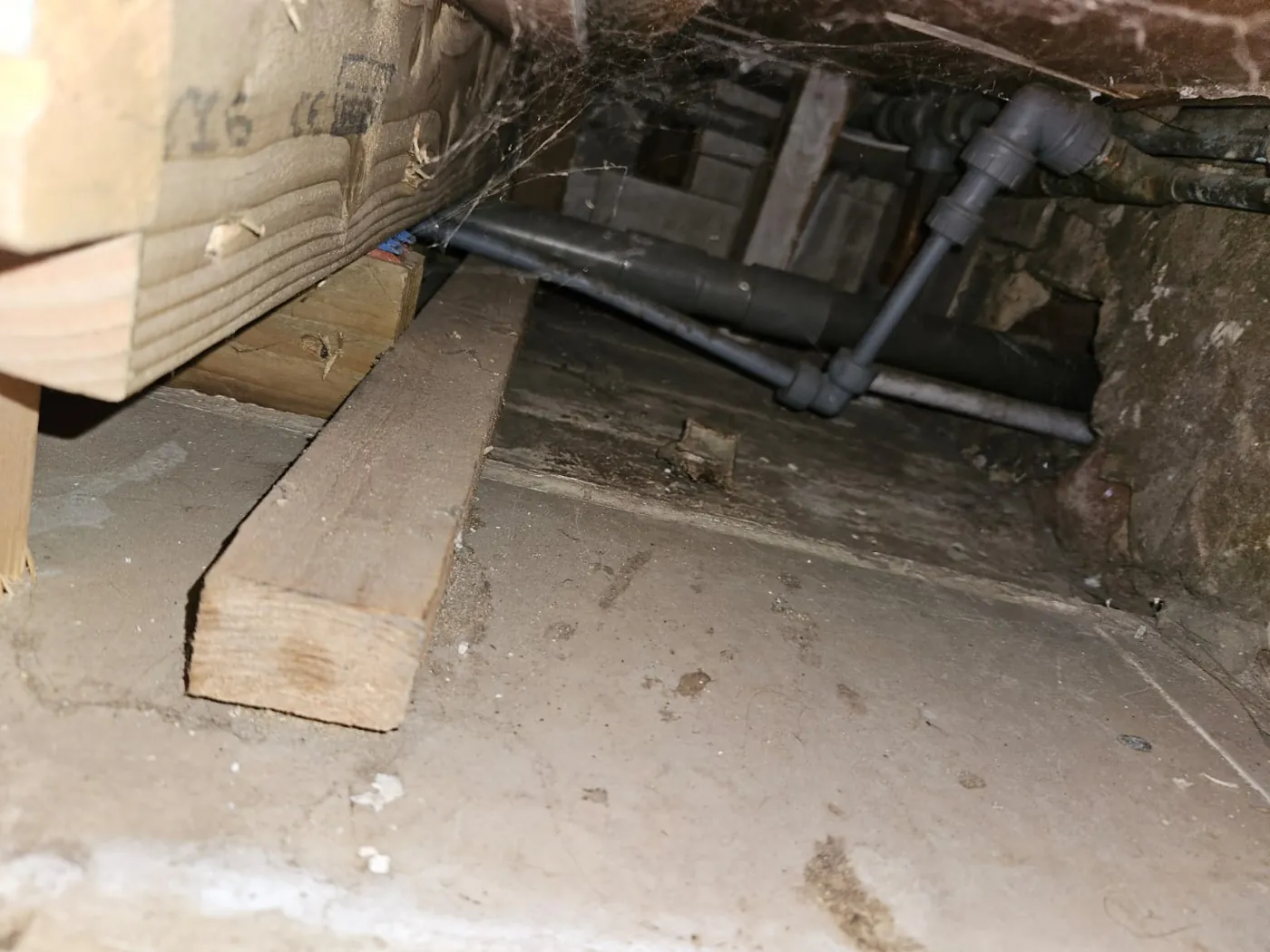 Heating pipework run tight against the joists under a floor