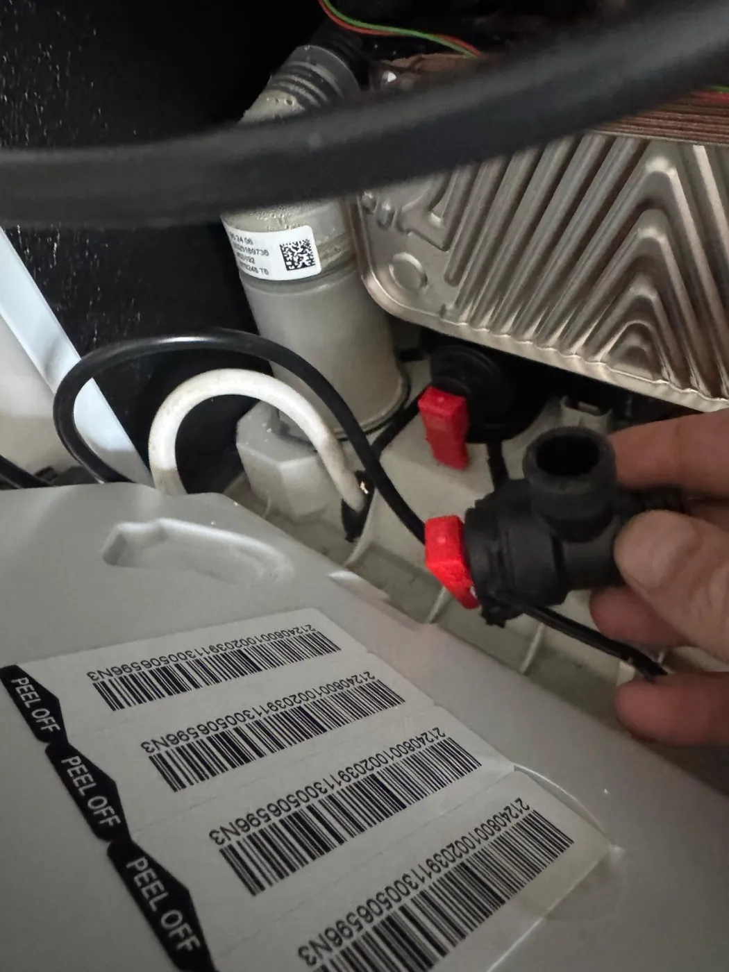 An engineer fitting a new pressure relief valve inside a boiler