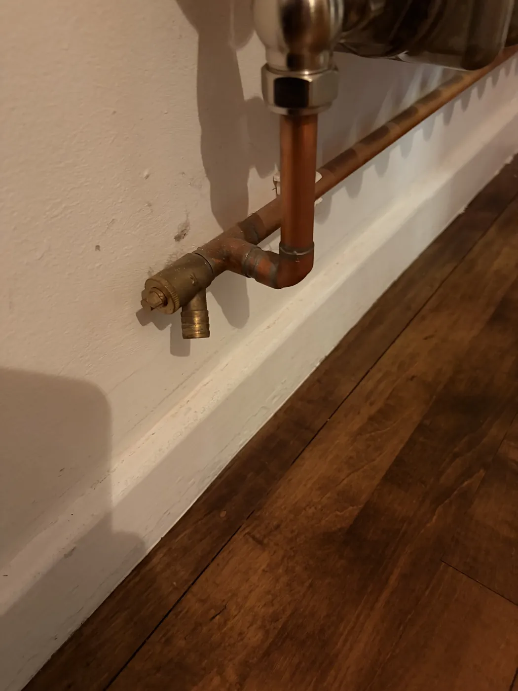 A drain-off valve on the pipe below a radiator