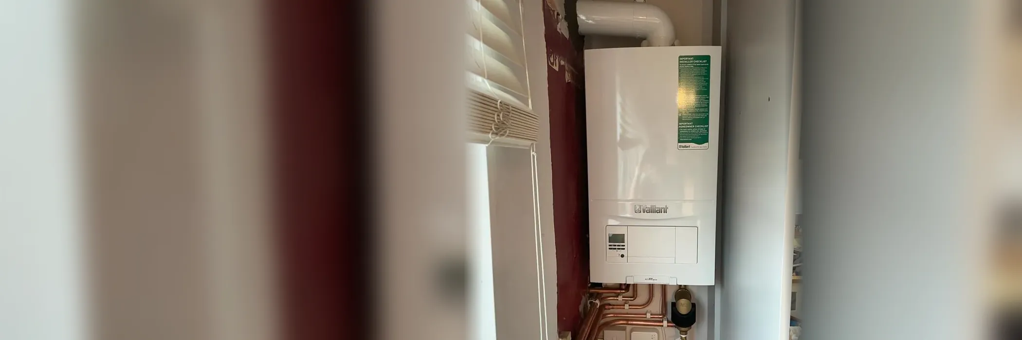 A Vaillant combi boiler fitted on a kitchen wall