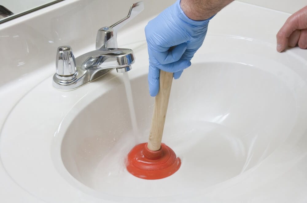 Unblocking a Sink with a Plunger image