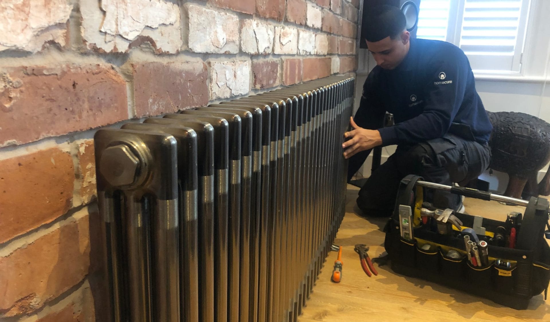 plumber working on radiator