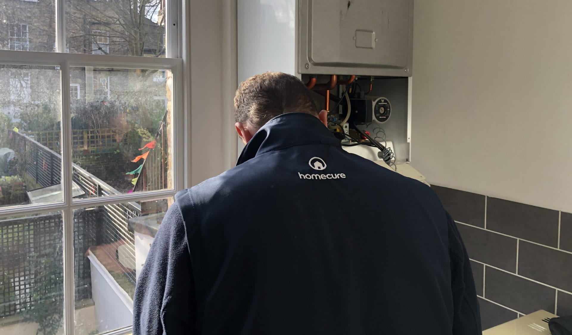 heating engineer working on boiler