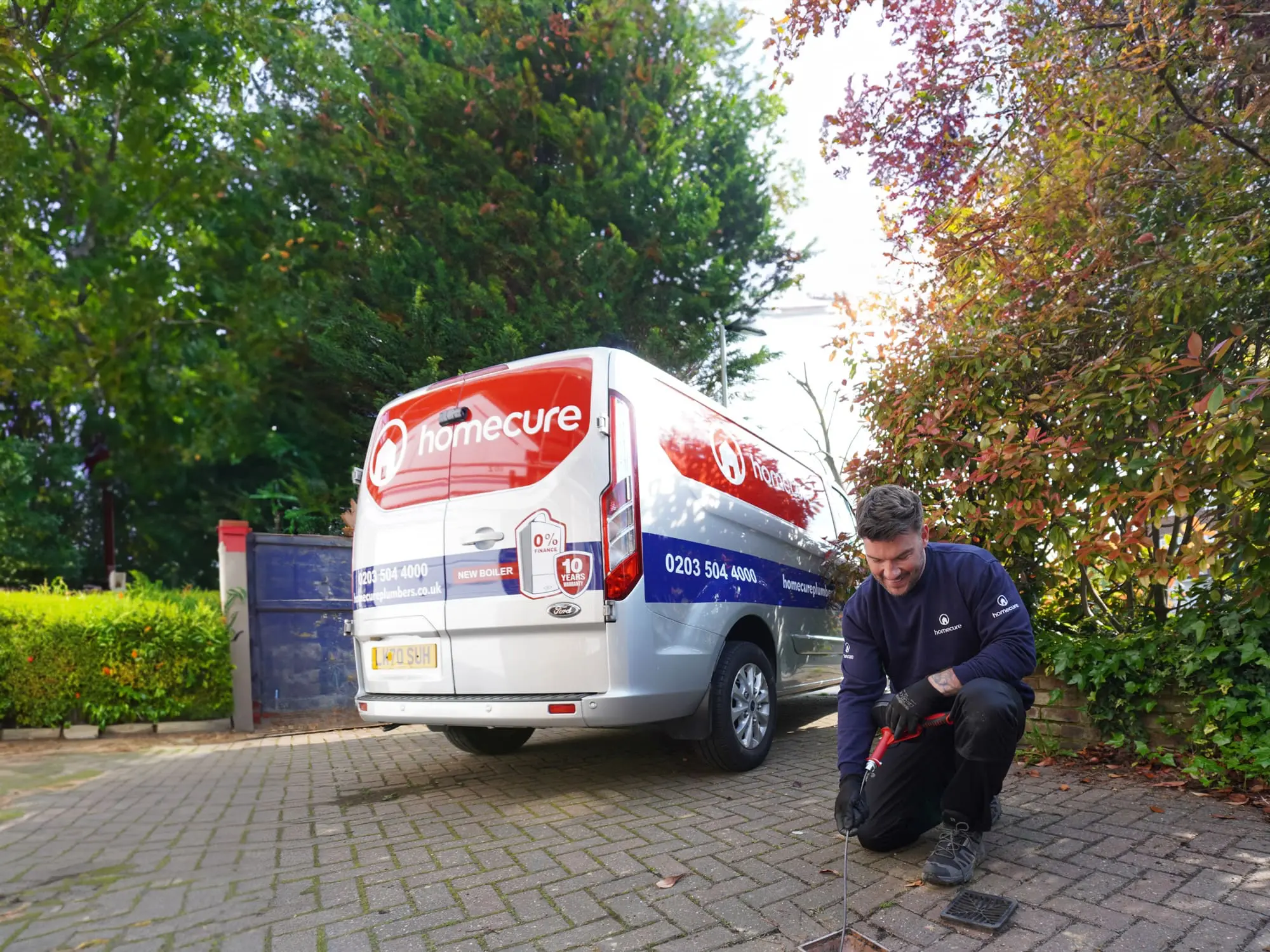 Homecure employee clearing a drain