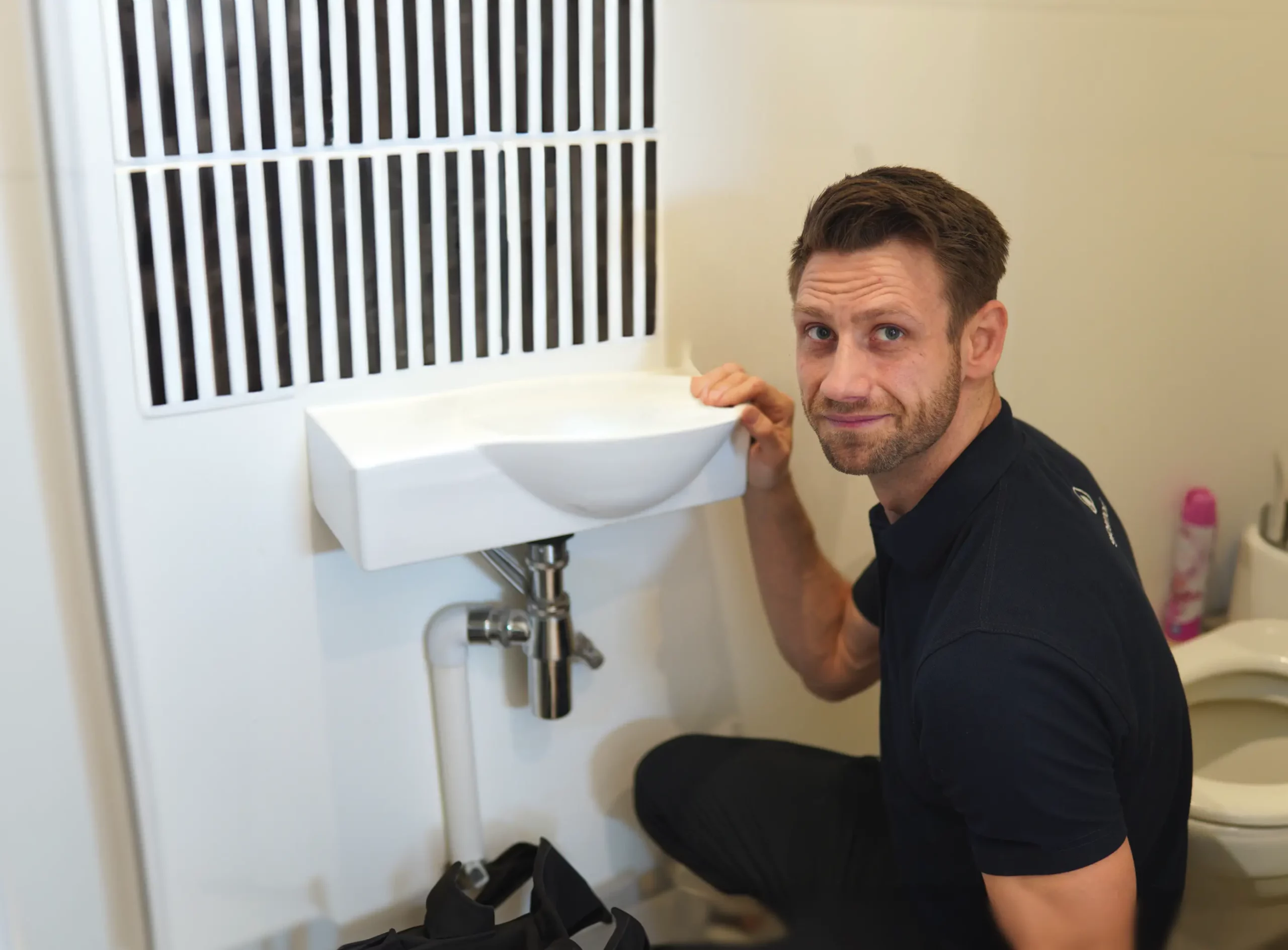 Plumber working on sink