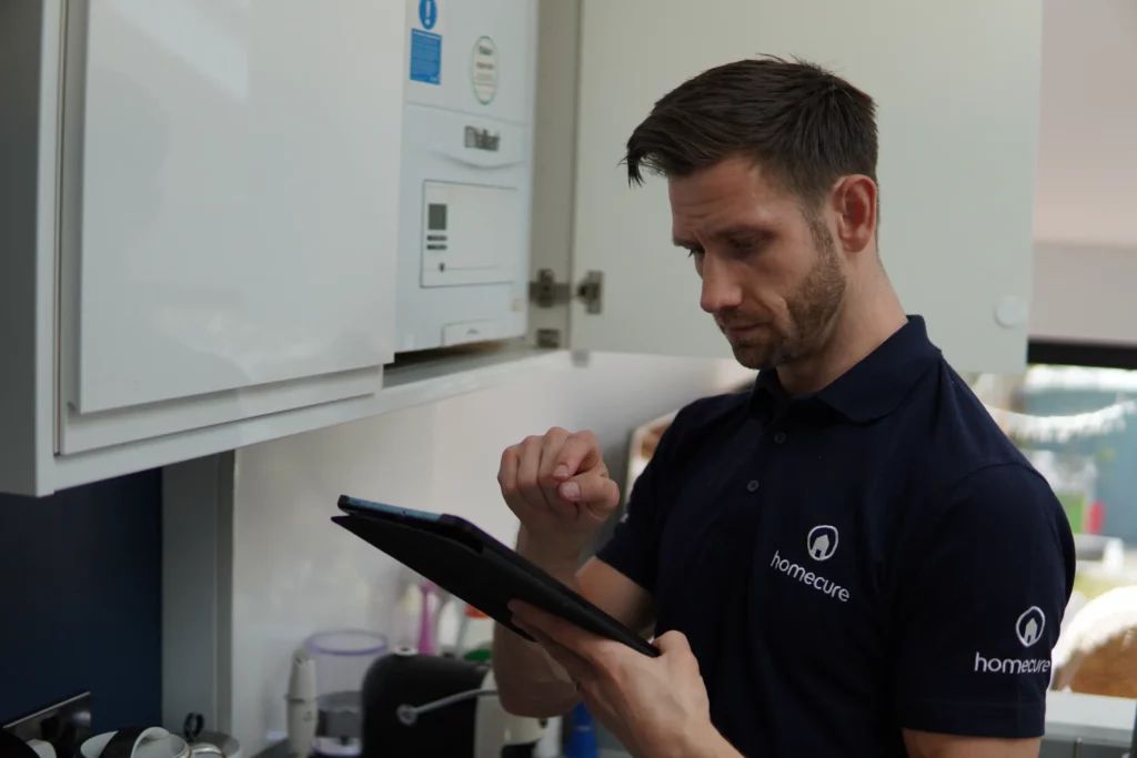 Homecure heating engineer in Surbiton servicing a boiler