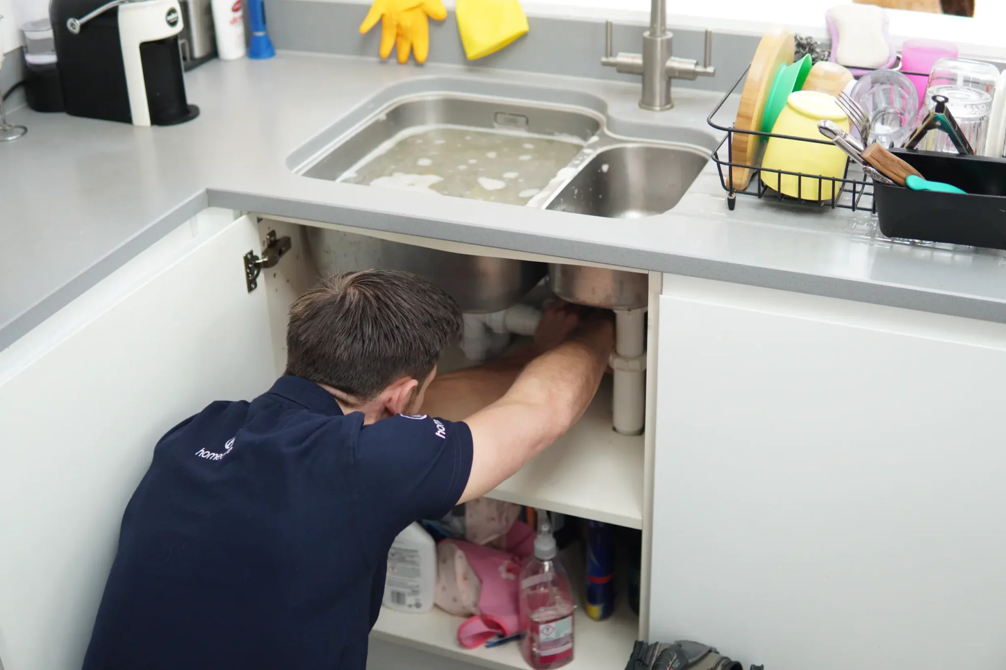 Plumber clearing sink blockage East London